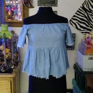 A blue denim half shirt off the sleeve shirt